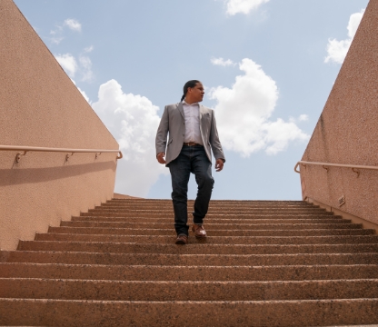 native american man walking down outside stairs